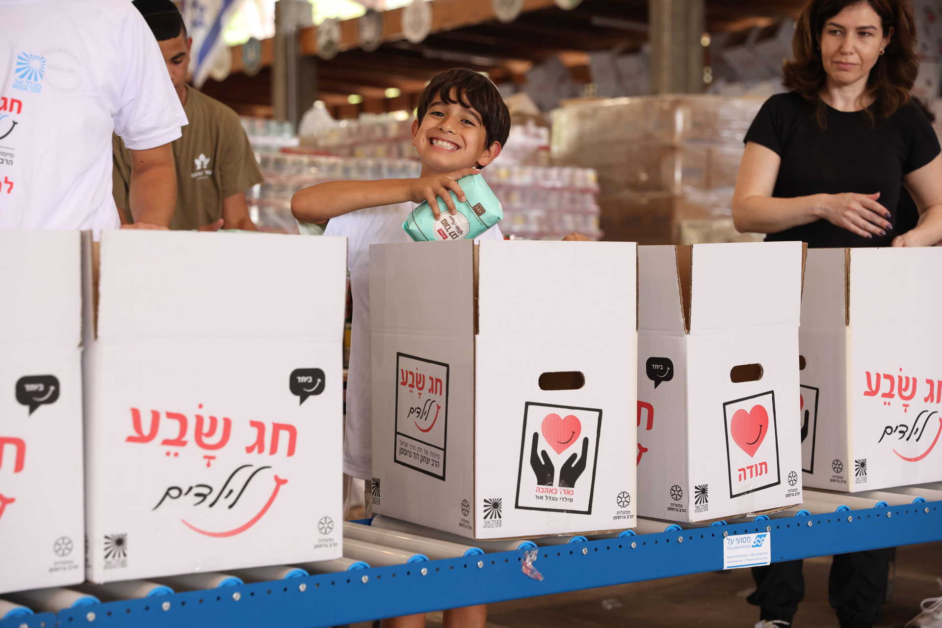 ילד אורז חבילות מזון לנזקקים